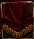A red velvet unveiling cloth