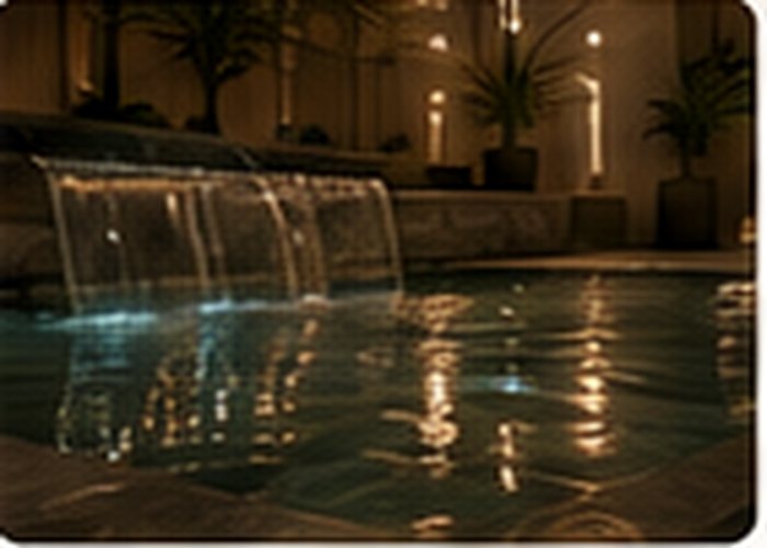 A warm indoor pool and waterfall in the LegacyLink Lodge wellness pavilion